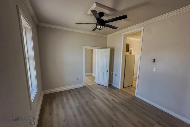 211 W Main St, East Helena, MT 59635 - unfurnished bedroom with wood finished floors, connected bathroom, crown molding, and a ceiling fan