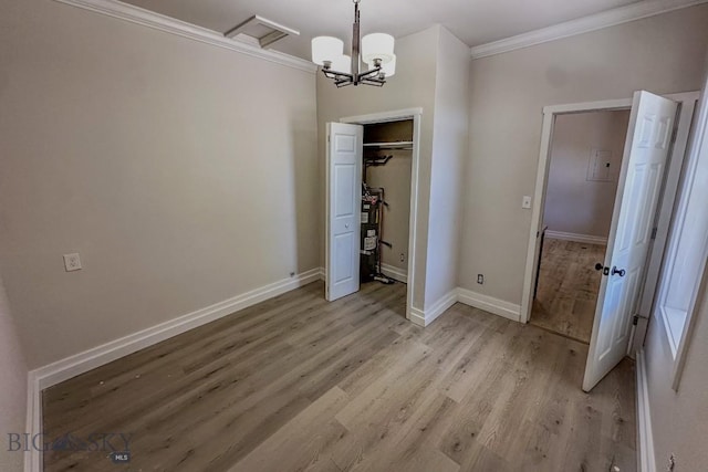 211 W Main St, East Helena, MT 59635 - unfurnished dining area with ornamental molding, light wood-style flooring, and a chandelier