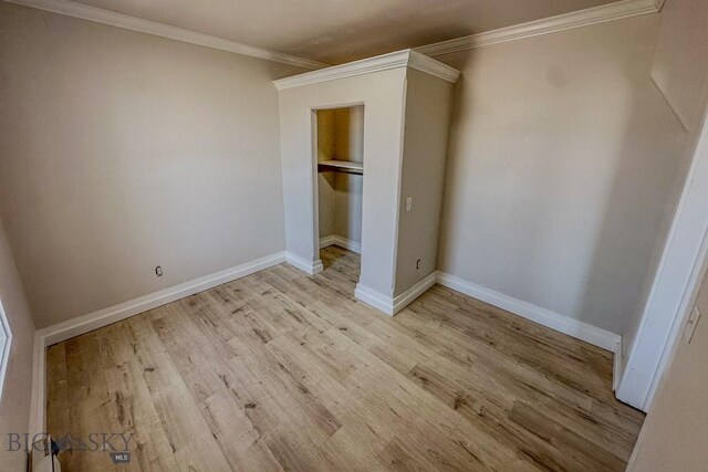 211 W Main St, East Helena, MT 59635 - unfurnished bedroom with ornamental molding, light wood-type flooring, and a closet
