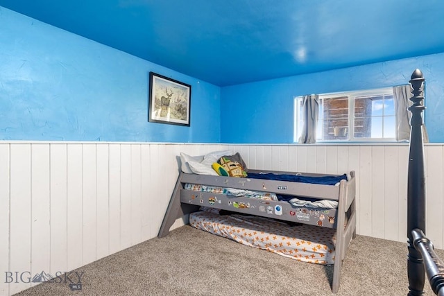251 Price Rd, Three Forks, MT 59752 - bedroom with wood walls, carpet flooring, and wainscoting