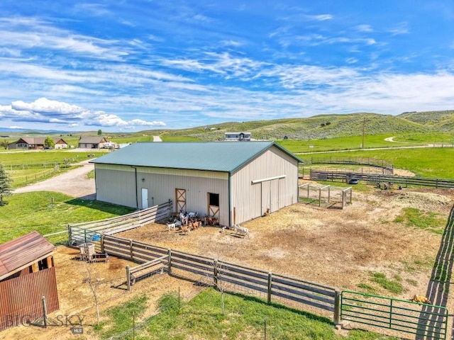 251 Price Rd, Three Forks, MT 59752 - view of outdoor structure featuring an exterior structure, a mountain view, and a view of rural / pastoral area