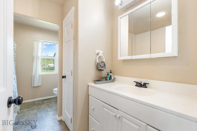 251 Price Rd, Three Forks, MT 59752 - bathroom featuring toilet, vanity, and baseboards
