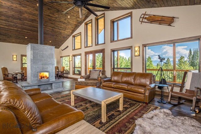 TBD Buttermilk Court, West Yellowstone, MT 59758 - living area with high vaulted ceiling, wood finished floors, ceiling fan, wooden ceiling, and a tiled fireplace