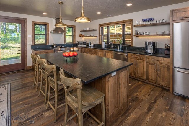 TBD Buttermilk Court, West Yellowstone, MT 59758 - kitchen featuring open shelves, stainless steel appliances, dark countertops, dark wood-style floors, and a sink