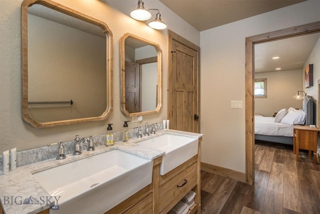 TBD Buttermilk Court, West Yellowstone, MT 59758 - bathroom featuring wood finished floors, double vanity, ensuite bath, and baseboards