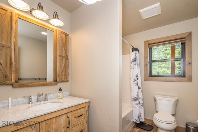 TBD Buttermilk Court, West Yellowstone, MT 59758 - bathroom featuring vanity, toilet, shower / bathtub combination with curtain, and wood finished floors