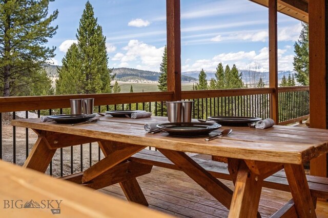 TBD Buttermilk Court, West Yellowstone, MT 59758 - wooden deck featuring a mountain view and outdoor dining area