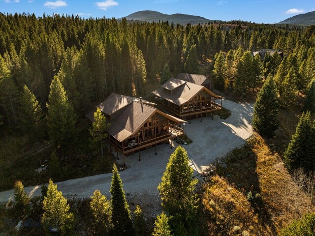 TBD Buttermilk Court, West Yellowstone, MT 59758 - aerial view of property and surrounding area featuring a forest and a mountain backdrop