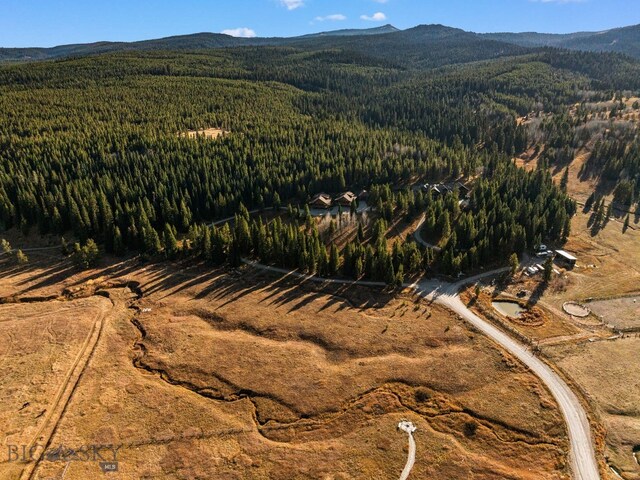 TBD Buttermilk Court, West Yellowstone, MT 59758 - aerial overview of property's location featuring a heavily wooded area and a mountainous background