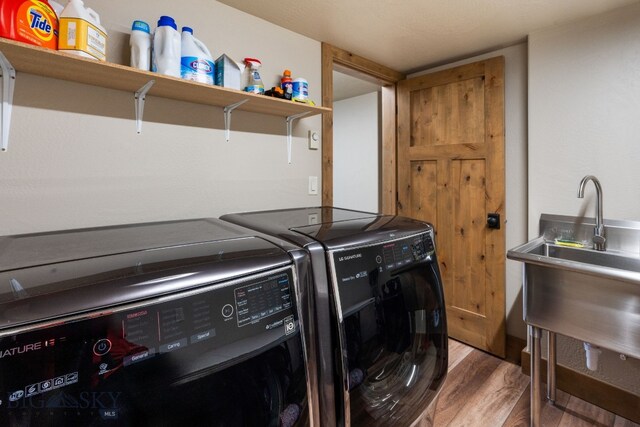 TBD Buttermilk Court, West Yellowstone, MT 59758 - washroom with washing machine and clothes dryer and wood finished floors