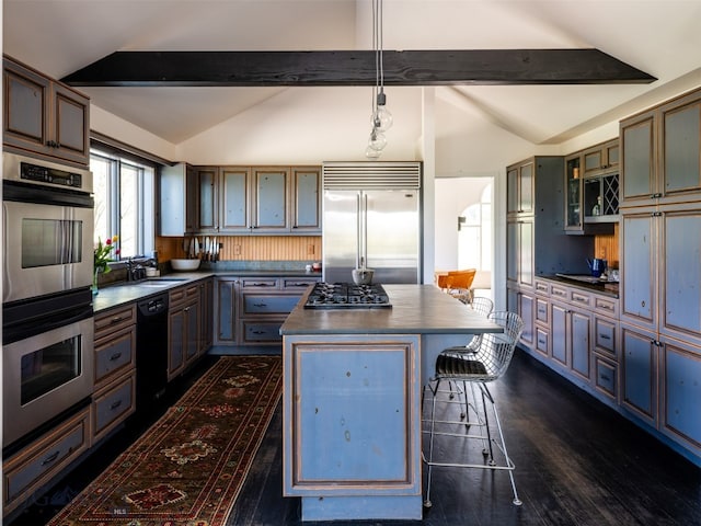 370 Star Ridge Rd, Bozeman, MT 59715 - kitchen featuring dark countertops, appliances with stainless steel finishes, dark wood-style floors, and a center island