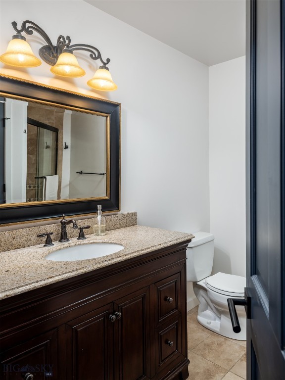 370 Star Ridge Rd, Bozeman, MT 59715 - bathroom with toilet, tile patterned floors, and vanity