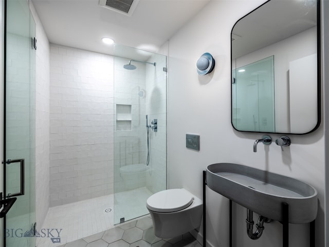 370 Star Ridge Rd, Bozeman, MT 59715 - bathroom with toilet, tiled shower, tile patterned floors, and recessed lighting