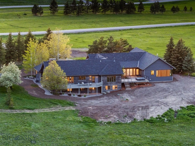 370 Star Ridge Rd, Bozeman, MT 59715 - back of house with a deck, a lawn, roof with shingles, and dirt driveway