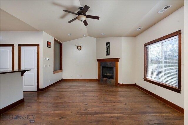 4364 Brookside Ln, Bozeman, MT 59718 - unfurnished living room featuring a ceiling fan, a tiled fireplace, baseboards, dark wood finished floors, and vaulted ceiling