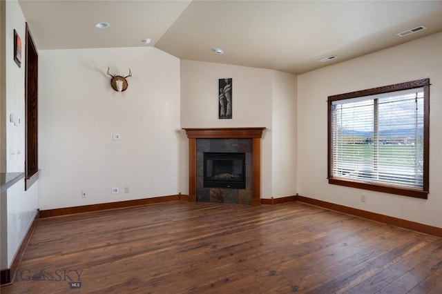 4364 Brookside Ln, Bozeman, MT 59718 - unfurnished living room with wood-type flooring, lofted ceiling, a tile fireplace, baseboards, and recessed lighting