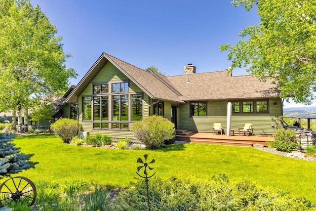2594 Star Ridge Rd, Bozeman, MT 59715 - back of property featuring a wooden deck, a chimney, a lawn, and a shingled roof