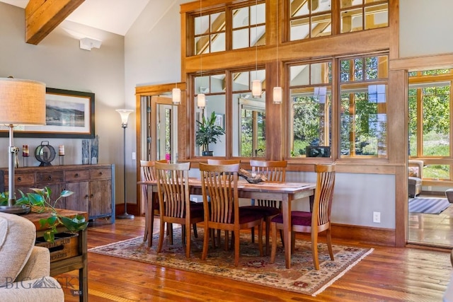 2594 Star Ridge Rd, Bozeman, MT 59715 - dining space featuring high vaulted ceiling, hardwood / wood-style floors, and beam ceiling