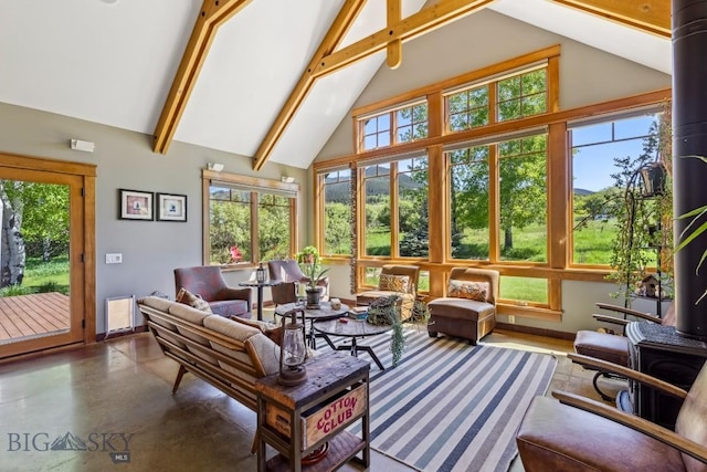 2594 Star Ridge Rd, Bozeman, MT 59715 - living room with high vaulted ceiling, healthy amount of natural light, concrete floors, beam ceiling, and radiator heating unit