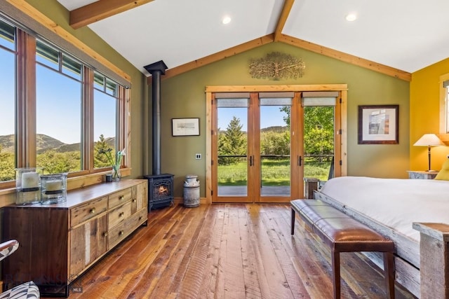 2594 Star Ridge Rd, Bozeman, MT 59715 - bedroom with a wood stove, wood-type flooring, and access to outside