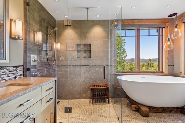 2594 Star Ridge Rd, Bozeman, MT 59715 - bathroom featuring a shower stall, vanity, a freestanding tub, tile walls, and recessed lighting