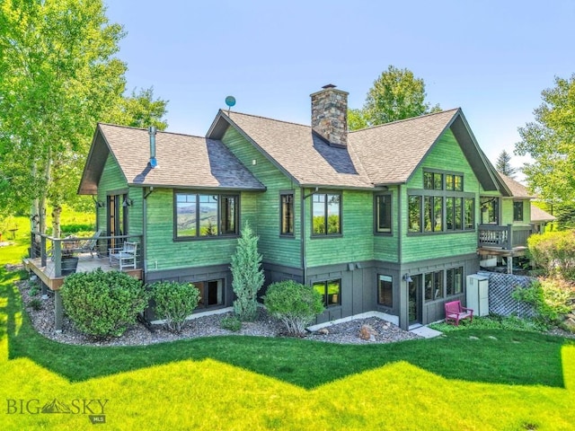 2594 Star Ridge Rd, Bozeman, MT 59715 - rear view of property featuring a chimney, a yard, roof with shingles, and a wooden deck