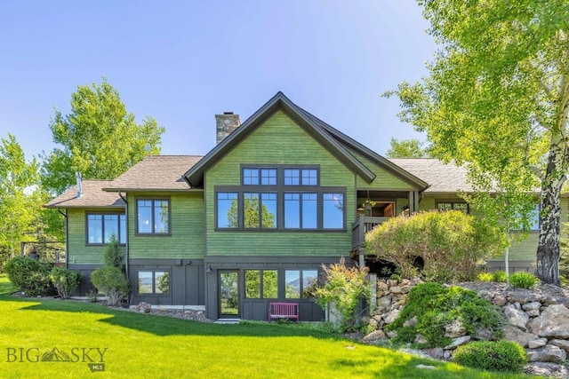 2594 Star Ridge Rd, Bozeman, MT 59715 - back of house with a yard, a chimney, and board and batten siding
