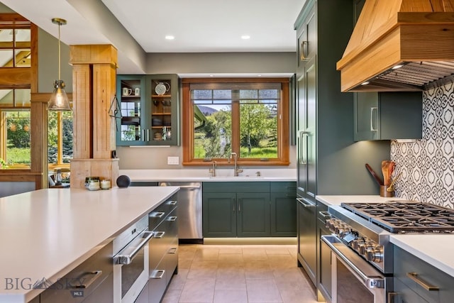 2594 Star Ridge Rd, Bozeman, MT 59715 - kitchen with appliances with stainless steel finishes, premium range hood, green cabinetry, light countertops, and recessed lighting