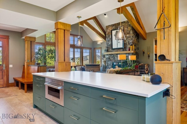 2594 Star Ridge Rd, Bozeman, MT 59715 - kitchen with healthy amount of natural light, beam ceiling, open floor plan, high vaulted ceiling, and green cabinetry