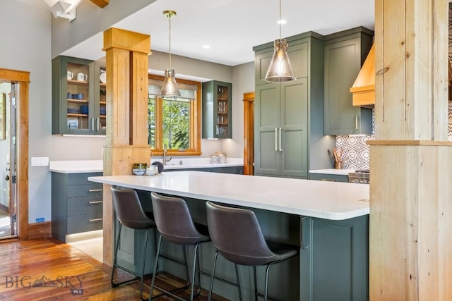 2594 Star Ridge Rd, Bozeman, MT 59715 - kitchen with green cabinetry, wood finished floors, glass insert cabinets, light countertops, and recessed lighting