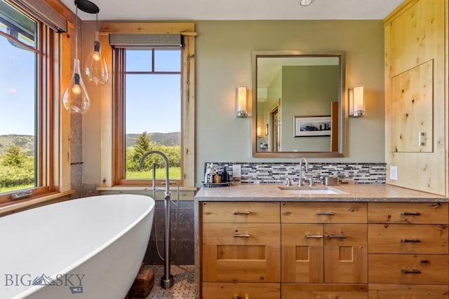 2594 Star Ridge Rd, Bozeman, MT 59715 - full bath featuring a freestanding tub, vanity, healthy amount of natural light, and backsplash