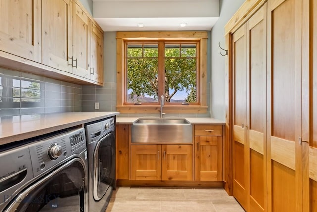 2594 Star Ridge Rd, Bozeman, MT 59715 - laundry area with cabinet space, independent washer and dryer, and light tile patterned floors