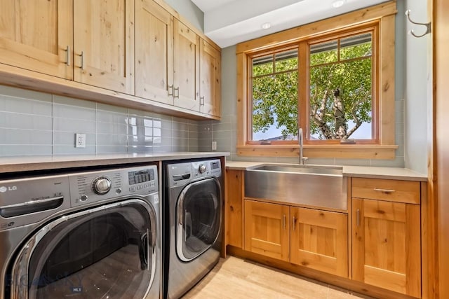2594 Star Ridge Rd, Bozeman, MT 59715 - laundry area featuring independent washer and dryer, cabinet space, and light wood-type flooring