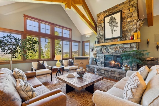 2594 Star Ridge Rd, Bozeman, MT 59715 - living room featuring a stone fireplace, high vaulted ceiling, wood finished floors, and beamed ceiling