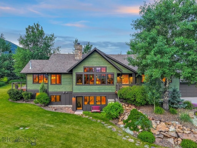 2594 Star Ridge Rd, Bozeman, MT 59715 - back of house featuring a chimney, a lawn, and roof with shingles