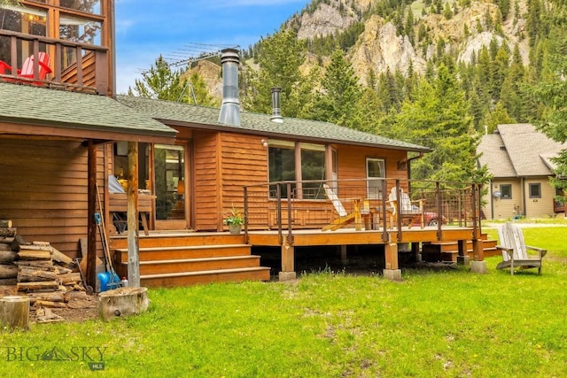 140 Luhn, Gallatin Gateway, MT 59730 - rear view of house with a yard, a deck with mountain view, and roof with shingles