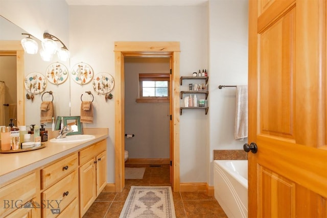 975 Jessie Way, Bozeman, MT 59715 - bathroom with vanity, a garden tub, toilet, and tile patterned flooring