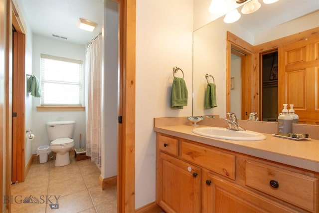 975 Jessie Way, Bozeman, MT 59715 - bathroom with toilet, vanity, tile patterned floors, baseboards, and a shower with curtain