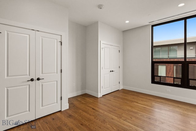 5 W Mendenhall St Unit 510, Bozeman, MT 59715 - unfurnished bedroom featuring baseboards, wood finished floors, and recessed lighting