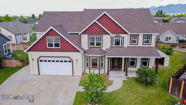 2475 Rose St, Bozeman, MT 59718 - view of front of house with an attached garage, a porch, driveway, roof with shingles, and a mountain view