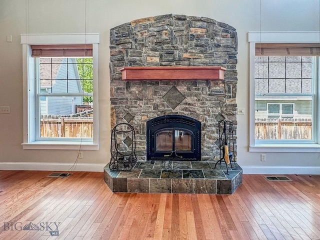 2475 Rose St, Bozeman, MT 59718 - detailed view of wood finished floors, baseboards, and a stone fireplace