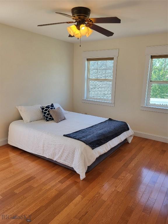 2475 Rose St, Bozeman, MT 59718 - bedroom with wood finished floors, baseboards, and a ceiling fan