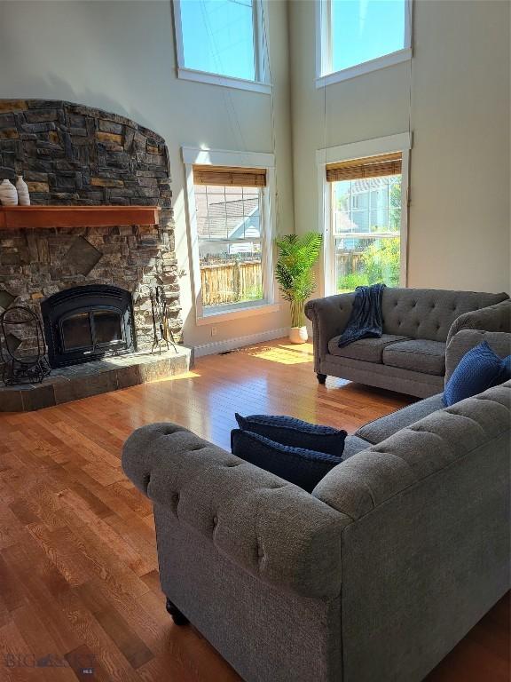 2475 Rose St, Bozeman, MT 59718 - living room featuring a towering ceiling, wood finished floors, and a fireplace