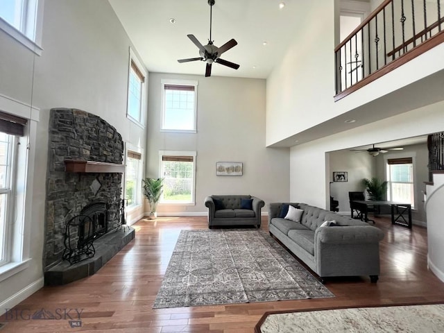 2475 Rose St, Bozeman, MT 59718 - living room featuring ceiling fan, a high ceiling, healthy amount of natural light, and wood finished floors