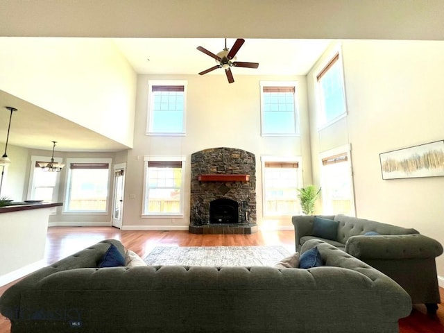 2475 Rose St, Bozeman, MT 59718 - living room with a towering ceiling, wood finished floors, ceiling fan, and a fireplace