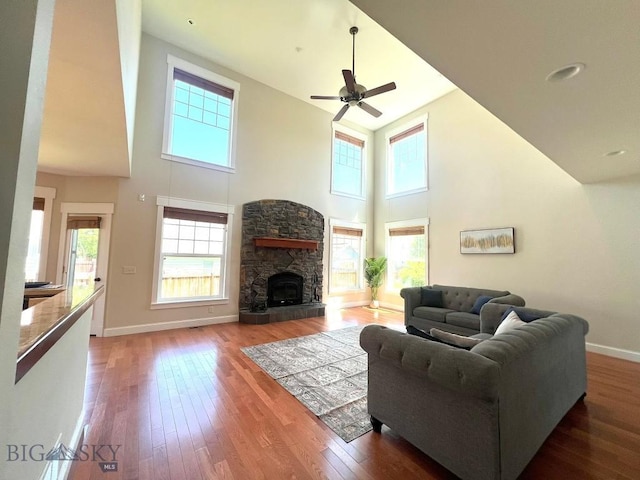 2475 Rose St, Bozeman, MT 59718 - living room with high vaulted ceiling, hardwood / wood-style floors, ceiling fan, and a stone fireplace