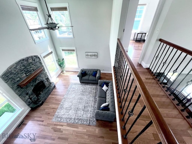 2475 Rose St, Bozeman, MT 59718 - living room featuring healthy amount of natural light, wood finished floors, a towering ceiling, and stairs