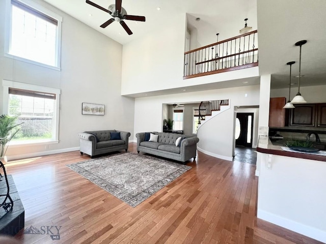 2475 Rose St, Bozeman, MT 59718 - living area with a ceiling fan, a towering ceiling, wood finished floors, and stairs