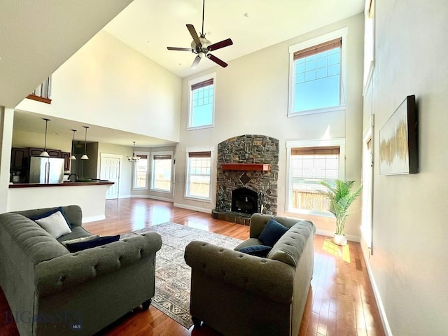 2475 Rose St, Bozeman, MT 59718 - living area with a towering ceiling, wood finished floors, ceiling fan, and a stone fireplace