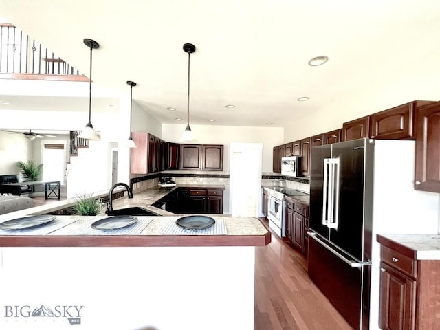 2475 Rose St, Bozeman, MT 59718 - kitchen with stainless steel appliances, ceiling fan, tasteful backsplash, a peninsula, and wood finished floors
